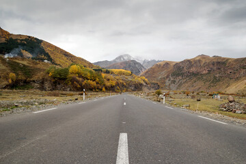 Empty road between Caucasus Mountains in autumn time.