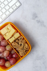 Food in Plastic containers ready to eat with Cheese, grapes and nuts