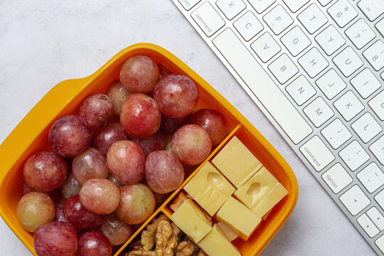 Food in Plastic containers ready to eat with Cheese, grapes and nuts