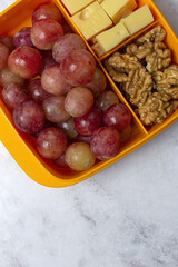 Food in Plastic containers ready to eat with Cheese, grapes and nuts