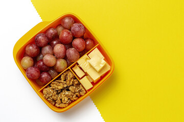 Food in Plastic containers ready to eat with Cheese, grapes and nuts