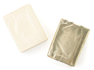 Processed cheese rectangular in packaging and without packaging on a white background, isolated. The view from top