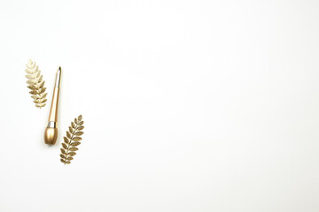 Golden eyeliner on the white background. Make-up tool