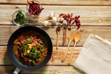 Stir fried hot and spicy sauce with pork, crispy basil leaf on top, served together with aromatic jasmine rice, an authentic popular traditional Thai food 