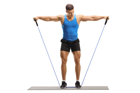 Full length portrait of a muscular guy exercising with a resistance band