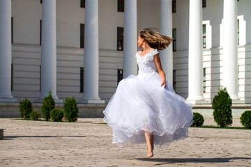 Fototapeta na wymiar Young beautiful girl in ballroom prom dress