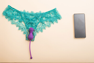 Green lace panties kegel trainer and smartphone. Vibrator synchronized with the application on the...