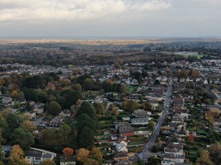 aerial view of Corfe Mullen in Dorset showing semi-rural location and forest in the background