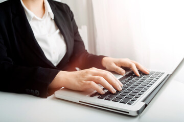 Businessman hands working with finances about cost and and laptop with tablet, smartphone at office in morning light