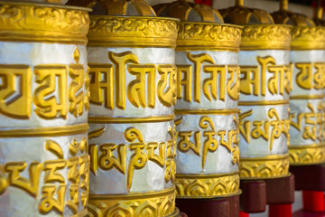 Golden prayer wheel in Buddhist monastery