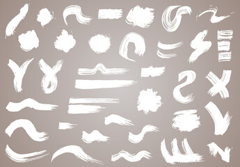 Naklejka premium Paint brush. White ink grunge brush strokes. Vector paintbrush set. Grunge design elements. Painted ink stripes