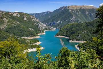 Fototapeta na wymiar Beautiful landscape Mountain lake of azure color. Oyster farm. View from above. Sunny day, clouds. Montenegro.