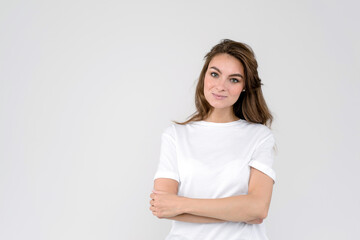 Portrait of smiling woman, isolated on white background, with folded arms