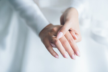 Close-up photo, beautiful hands of the bride with a wedding ring, and wedding bouquets