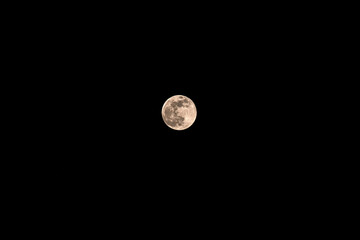 Full moon in the dark sky. Black night background.