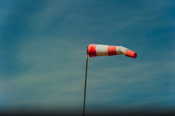 wind indicator at the airfield against the blue sky.