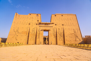 Facade with drawing of pharaohs of the Temple of Edfu in the city of Edfu, Egypt. On the bank of...
