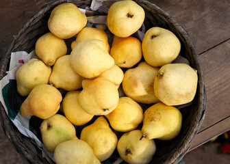 Yellow pears in a wicker basket.