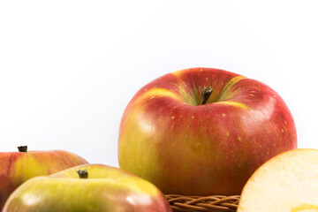 A lot of apples, one on top of another, banner and harvesting on the theme of fruits, on a white isolated background