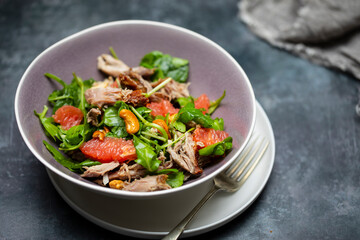 Salad with pulled duck, cashew nuts and grapefruit