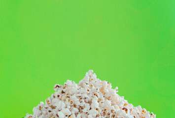 A slide of popcorn on a green background and a place for an inscription