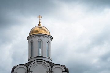  White church with golden dome and cross 