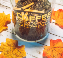 Coffee Beans and Cinnamon Sticks in a jar saying 
