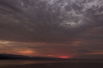 gray and red sunrise over the sea