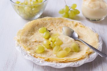 Crepes with grapes and pastry cream