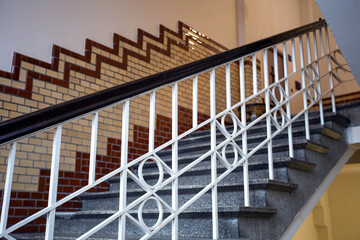 Obraz premium Old historic building with luxury stairs and tiled wall, beautiful marble design of old building and white handrail