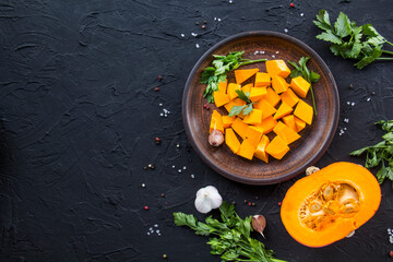 Beautifully chopped pumpkin salad, herbs, and ingredients for the dish. Creative atmospheric decoration