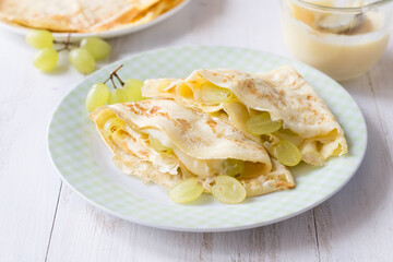 Crepes with grapes and pastry cream