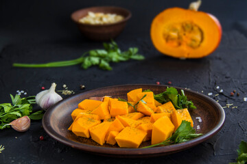 Beautifully chopped pumpkin salad, herbs, and ingredients for the dish. Creative atmospheric decoration