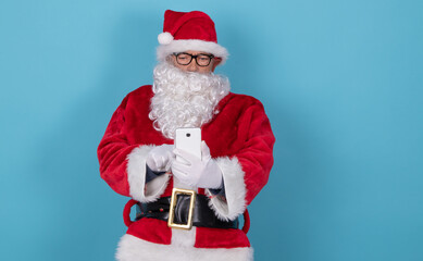santa claus isolated on background with mobile phone
