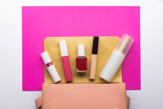 Travel set of decorative cosmetic products like lipstick and nail polish with micellar water for summer.