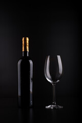 wine bottle and glass with black background