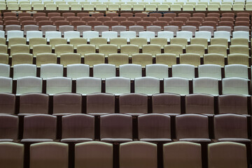 Rows of vacant spectators seats in theater. Abstract background.