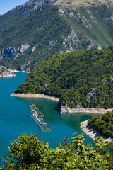 Fototapeta na wymiar Beautiful landscape Mountain lake of azure color. Oyster farm. View from above. Sunny day, clouds. Montenegro.