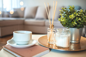 Candle and aromatic reed freshener on table in spa salon. aroma liquid in glass bottle with reed sticks. aroma Diffuser In Luxury in bedroom. Hygge. Scandinavian home decor candles, fragrance, books