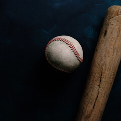 baseball with wood bat on dark background