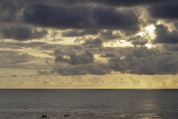 The silhouette of surfers at Kuta beach, Bali.