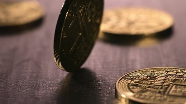 Bitcoin spinning on top of a steel surface in super slow motion. 