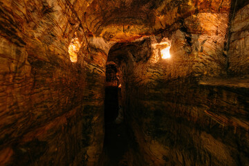 Ancient narrow underground passage in sandstone at old underground monastery