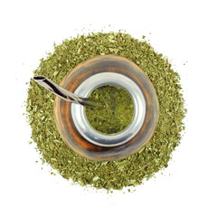 Yerba mate drink in calabash gourd with steel bombilla on dry tea leaf (Ilex paraguariensis)...