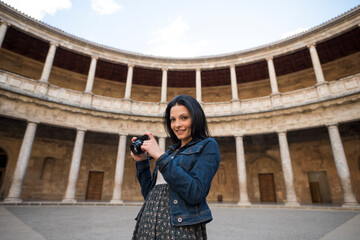 Tourist young woman in Carlos V palace, in "La Alhambra".Granada, Spain.