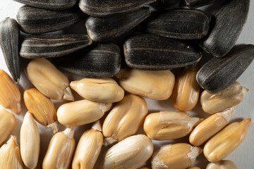 Sunflower seeds on a white background, unpeeled and peeled. Without a shell. Macro.