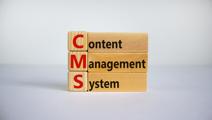Concept words 'CMS, content management system' on cubes and blocks on a beautiful white background. Copy space, business concept.