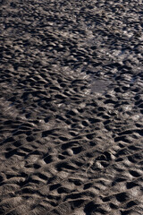 Textures made by water and wind on the sand at the beach