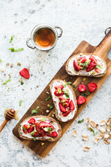 Sandwich with strawberries, soft cheese and honey