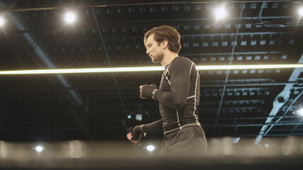 Active fit man warming up before boxing at gym. Male boxer jumping in sport club